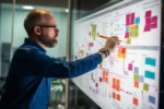 UX strategist analyzing website layout and user experience planning board with sticky notes and interface diagrams